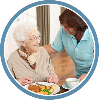 Woman Helping Older Woman With Dinner